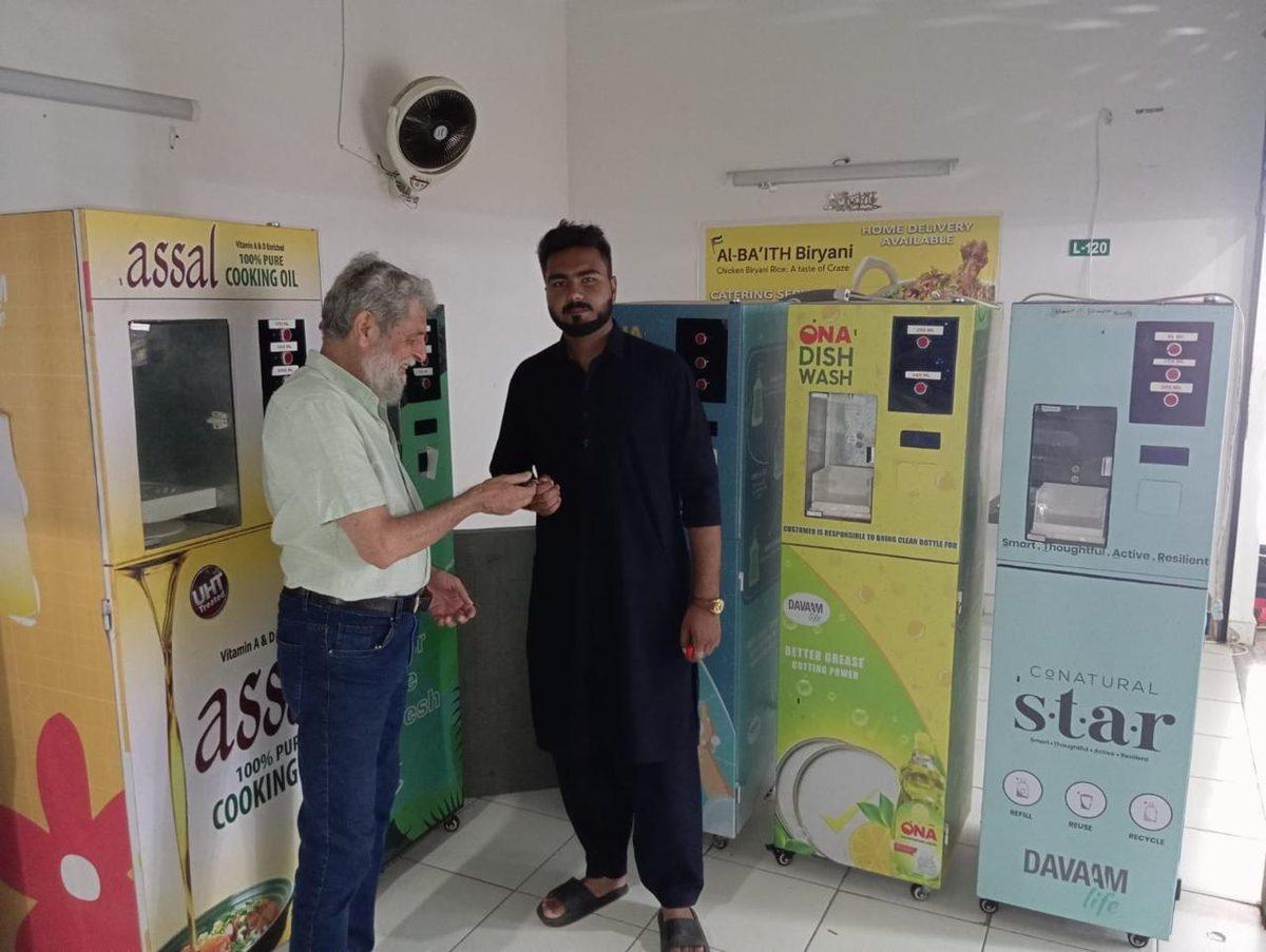 A shopkeeper refilling a customer's bottle