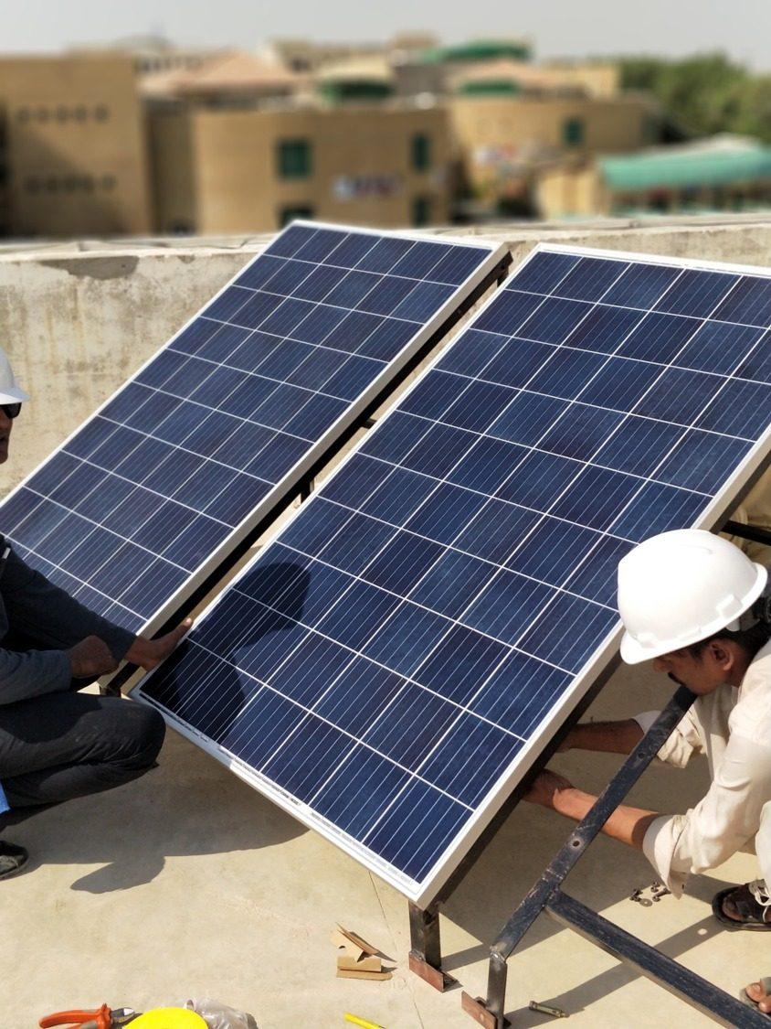 Davaam co-founders on a rooftop installation site