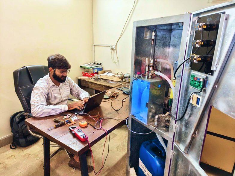 Engineer testing electronics at a workbench
