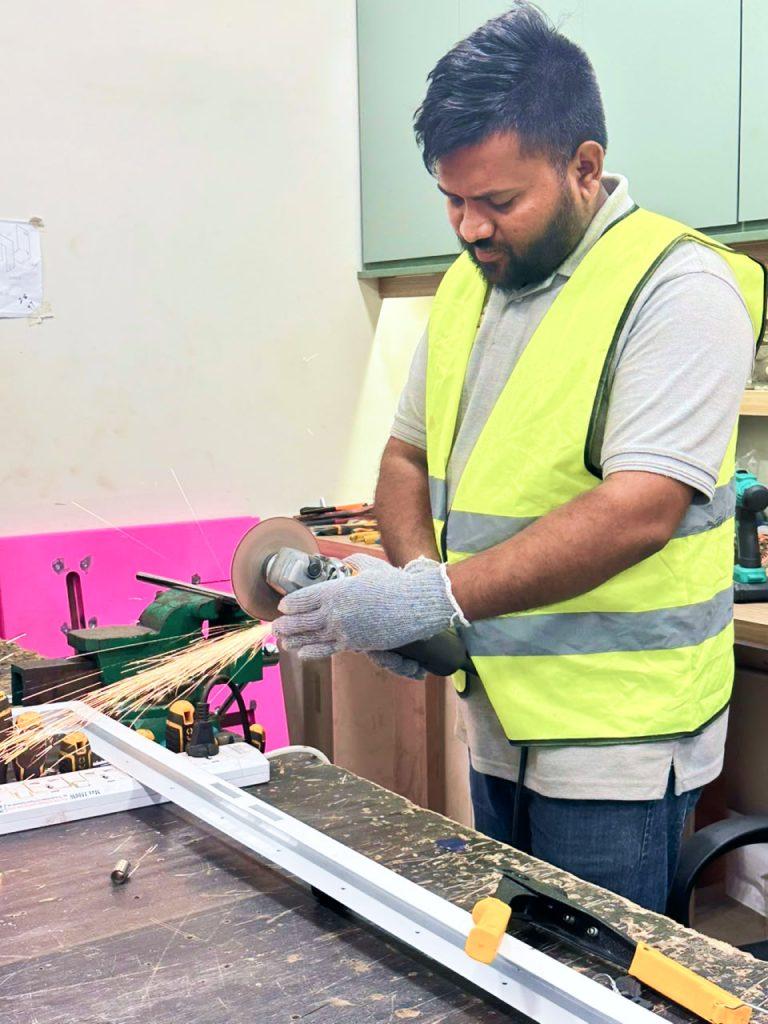 Technician cutting metal stock