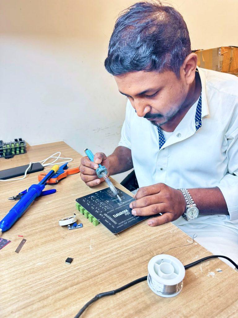 Engineer soldering a control board