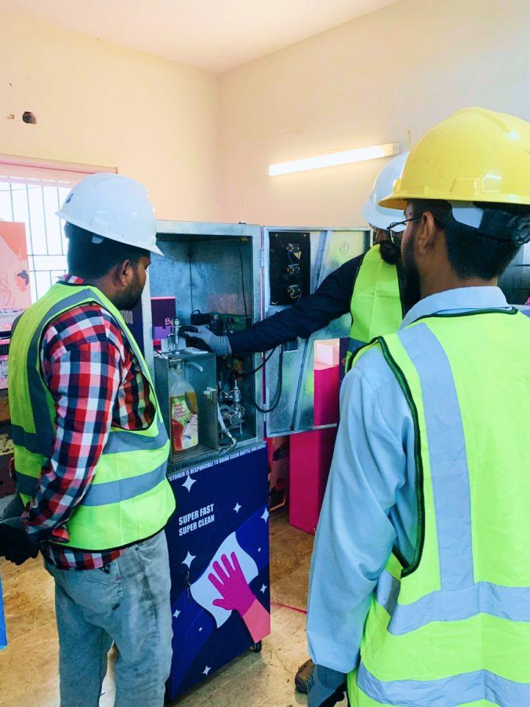 Two technicians assembling a vending machine